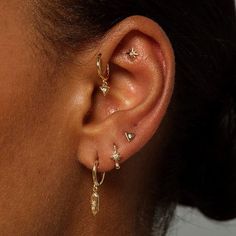 a close up of a person with ear piercings on their ears and behind the ear