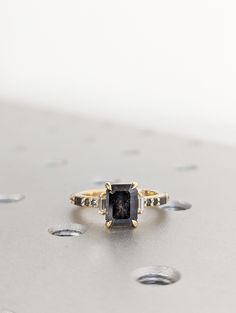 a black diamond ring sitting on top of a table