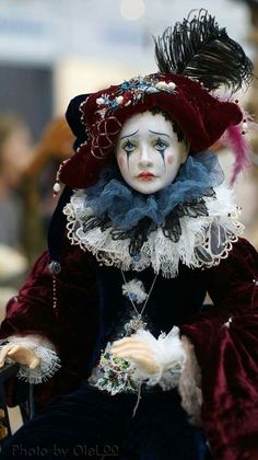 a close up of a doll wearing a costume