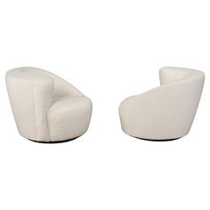 two white chairs sitting next to each other