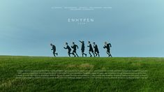 a group of people running across a grass covered field with the words enhypen on it