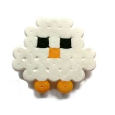 a white sheep with black eyes and orange feet