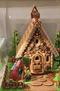 an elaborate gingerbread house in a display case