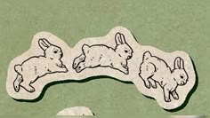 an image of three rabbits on the ground