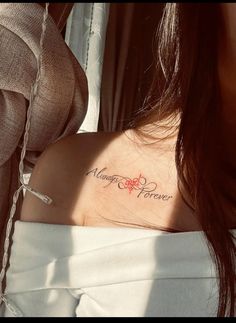 a woman's chest with the word marriage forever tattooed on her left side ribcage