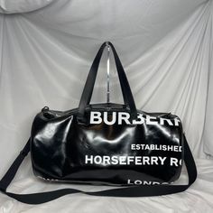 The Burberry Graphic Kennedy Duffle Bag Is In Good Condition With Minor Wear And Tear. It Does Not Come With A Box Or Dust Bag. It Has Minor Signs Of Use On The Bottom And Side Opposite Of The Graphics. It Is Still Overall In Good Condition. Black Duffle Bag, Burberry Bag, Duffel Bag, Womens Tote Bags, Duffle Bag, Burberry, Dust Bag, Overalls, Black And White