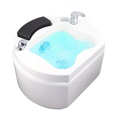 a white bath tub with blue water in it