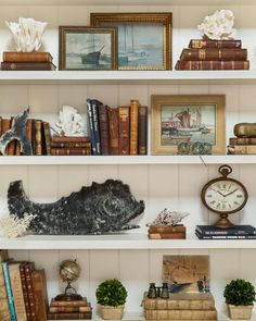 the bookshelves are filled with many different types of books and other decorative items