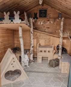 the inside of a cabin with wooden walls and flooring is decorated in white wood