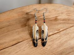 These hand painted bone feather earrings are made by the Cree Nation. I add the hypoallergenic stainless steel findings to the earrings. This set features the Lakota four directions design.  The feather pendants each measure approximately 5/16 by 2 3/16 and weigh 5 grams. The four directions in Lakota culture are east, south, west, and north, and each direction is associated with a color and specific meaning:  East: Yellow, represents the beginning of a new day, wisdom, understanding, and enligh Lakota Culture, Four Directions, Earrings Native American, Lake Elsinore, Feather Pendant, Feather Earrings, South West