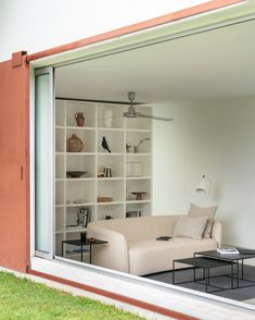 a living room filled with furniture next to a sliding glass door that opens onto a patio