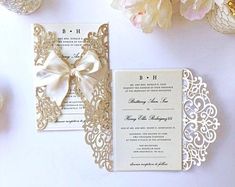 the wedding stationery is laid out next to flowers