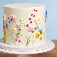 a white cake with flowers painted on it