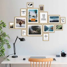 a white desk topped with a wooden chair next to a wall filled with pictures