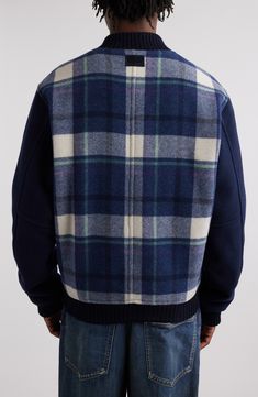 Subtle branding marks the matte snaps and back yoke of this plaid varsity jacket framed by solid sleeves and tailored from a nylon-reinforced wool blend. Front snap closure Blade collar Front welt pockets Ribbed cuffs and hem 75% wool, 25% polyamide Dry clean Imported Designer Clothing Blue Wool Outerwear With Ribbed Collar, Wool Outerwear With Ribbed Collar For College, Welt Pockets, Isabel Marant, Welt Pocket, Snap Closure, Varsity Jacket, Wool Blend, Designer Clothing