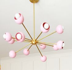 a pink and white chandelier hanging from the ceiling