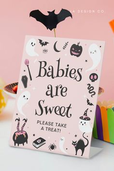 a sign that says babies are sweet please take a treat with bats and witches on it