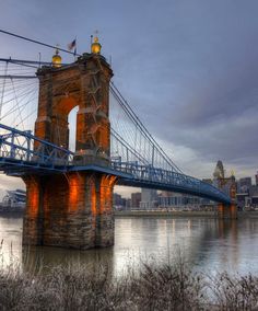 the bridge is very tall and has many lights on it