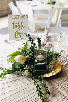 there is a table with flowers and candles on it