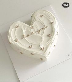 a heart shaped cake sitting on top of a card