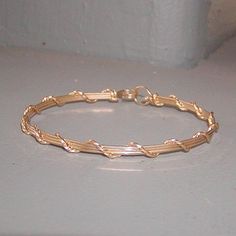 A pretty little bracelet of four strands of 14kt gold filled--three plain square wires, overwrapped with one strand of twist wire. Charming and feminine, and perfect to wear every day. Stackable with so many of my other wirewrapped bracelets! What a sweet graduation gift for a special young lady! Or just as nice for a birthday, Christmas, or Hanukkah. Of course, you can always treat yourself as well! The sturdy built-in hook and eye clasp is easy to get on and off by yourself. Choose your size f Gold Wire Wrapped 14k Gold-filled Bracelets, Gold Wire Wrapped Bracelets In 14k Gold Filled, Wire Wrapped 14k Gold Filled Bracelets, Adjustable 14k Gold Filled Wire Wrapped Bracelets, Gold Wire Wrapped Bracelets, Gold Wire Wrapped Bracelet Gift, Gift Gold Wire Wrapped Bracelet, Elegant 14k Gold Filled Hand-wrapped Bracelets, Minimalist Gold Hand Wrapped Bracelets