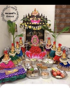 there are many small figurines sitting on the table next to bowls and plates