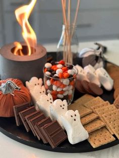 a plate with halloween treats and marshmallows on it