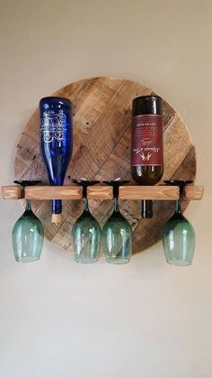 three wine glasses are sitting on a wooden shelf