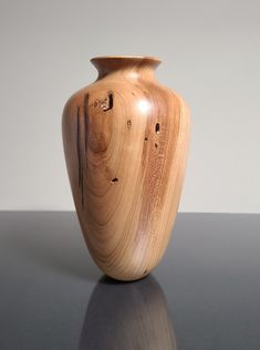 a wooden vase sitting on top of a table