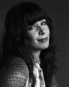 a black and white photo of a woman with long hair