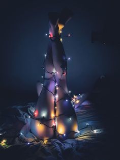 a christmas tree made out of plastic with lights on it's legs and arms