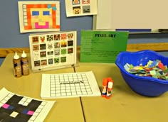 a table topped with lots of crafting supplies next to a blue bowl filled with crayons