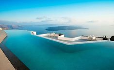 an empty swimming pool overlooking the ocean