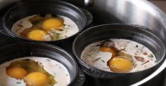 three eggs are being cooked in a pan