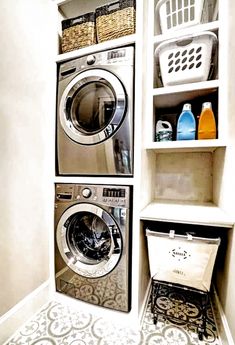 a washer and dryer in a small room with shelves on the wall above them