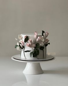 a white cake with pink and white flowers on top