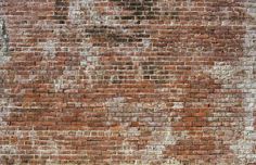 an old brick wall is painted red and white