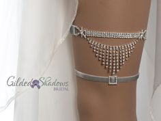 Elegant hanging crystal wedding garter set that adds just the right amount of sparkle. Includes a matching toss garter with a small crystal jewel detail in the middle. ❤ Crystal detail is about wide 5.5" wide and 2.5" high. ❤ Stretch band on the back is made to your measurement (please see measuring instructions below). ❤ Choose silicone lined satin (no slip) or velvet band (please see color options for each). ❤ Please select the center jewel for your toss garter from options in the last listing Silver Wedding Jewelry With Rhinestone Fringe, Silver Bridal Sets With Rhinestones For Wedding, Wedding Jewelry With Rhinestone Fringe In Crystal, Adjustable Rhinestone Bridal Accessories, Adjustable Bridal Accessories With Rhinestones, Silver Fitted Bridal Accessories, Adjustable Rhinestone Bridal Accessories For Wedding, Adjustable Silver Bridal Accessories For Marriage, Crystal Garter