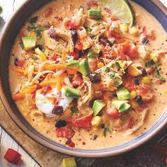 a bowl of soup with tortilla shells and vegetables