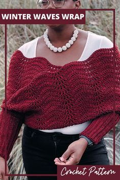 a woman wearing a red knitted sweater with the words winter waves wrap over her shoulders