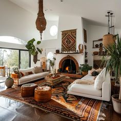 a living room filled with furniture and a fire place in the middle of an open floor plan