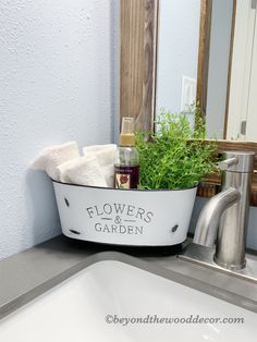 a bathroom sink with flowers and garden in it