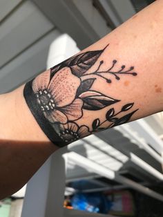 a person with a flower tattoo on their arm