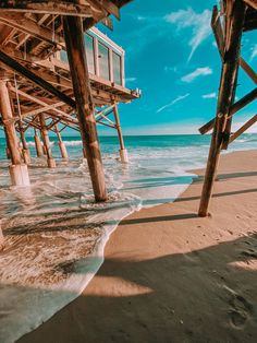 the ocean under a pier with waves coming in