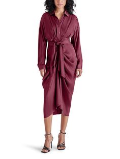 FRESH + SMART + REFINED SULA adds long cuffed sleeves to this shirt dress. A gathered tie-front construction snatches the waist and highlights the draping high-low skirt. Draped shirt dress Button front closure Collared V-neck Button cuff long sleeves Adjustable gathered tie-front waist High-low hem Washed satin finish Draped Shirt, Burgundy Shirt, Steve Madden Store, High Low Skirt, Button Front Dress, Casual Sandals, Cuff Sleeves, Satin Finish, Cross Body Handbags