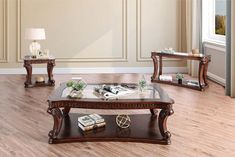 a living room filled with furniture and a coffee table on top of a hard wood floor