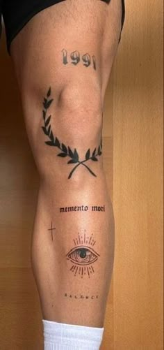 a man's leg with tattoos and an eye on it