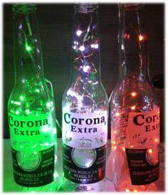 three bottles with lights on them sitting next to each other