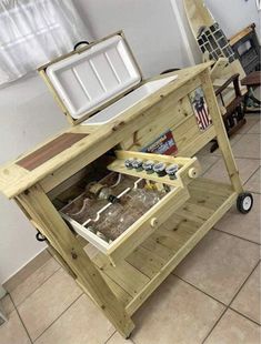 a wooden cart with two coolers on top of it and an ice chest in the middle