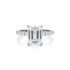 an emerald cut diamond ring with pave set shoulders